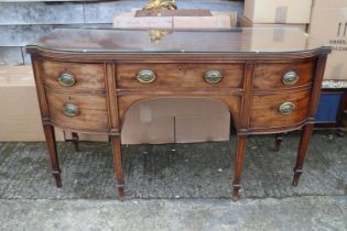 A George III mahogany break bowfront sideboard, fitted cupboard, centre drawer and cellarette (no