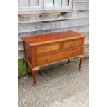 A 1920s carved walnut chest of two short and one long drawer, on cabriole supports and pad feet, 45"
