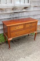 A 1920s carved walnut chest of two short and one long drawer, on cabriole supports and pad feet, 45"