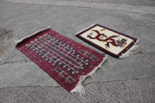 A Bokhara prayer rug of traditional design in shades of red, blue, brown, grey and natural, 32" wide