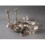 A pair of silver sauce boats, a pair of silver candlesticks, an Egyptian silver shallow dish, two .