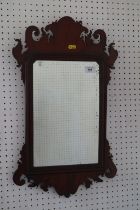 3-A walnut framed wall mirror of early 18th century design with shaped crest and plate, 23 1/2" high
