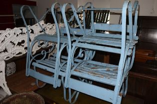 A set of four 19th century wrought iron, scroll work and wooden slat elbow chairs, (for restoration)