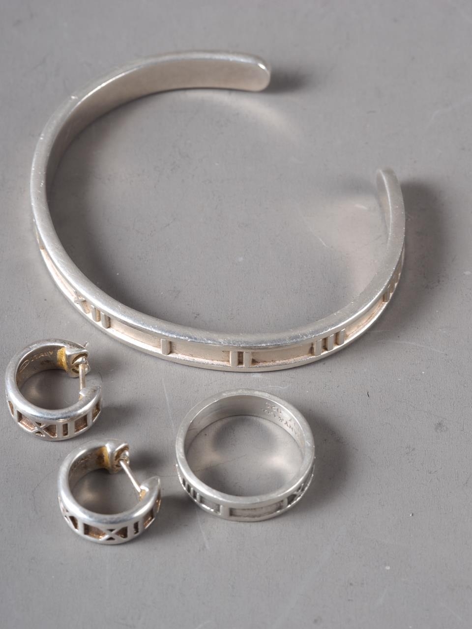 A suite of silver Jewellery, stamped Tiffany & Co, comprising a cuff bangle, ring and earrings,