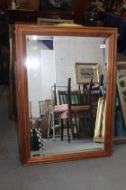 A waxed pine framed wall mirror with bevelled plate, 39" x 28"