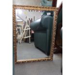 A rectangular gilt framed wall mirror, with pierced and scrolled decoration and bevelled plate, 16