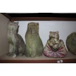 Three cast stone cat ornaments and a cast stone putto