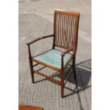 An Edwardian walnut, box and ebony strung vertical rail back elbow chair, on square taper