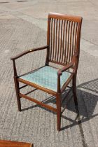 An Edwardian walnut, box and ebony strung vertical rail back elbow chair, on square taper