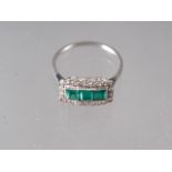 A platinum dress ring, set three square-cut emeralds, flanked diamonds, size P, 2.7g