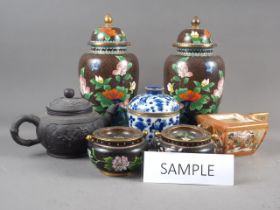 A pair of Chinese cloisonne jars and covers with flower and bird decoration on a brown ground,