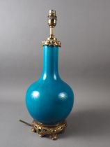 A Chinese turquoise glazed bottle vase with gilt metal mounts (now converted as a table lamp), 17