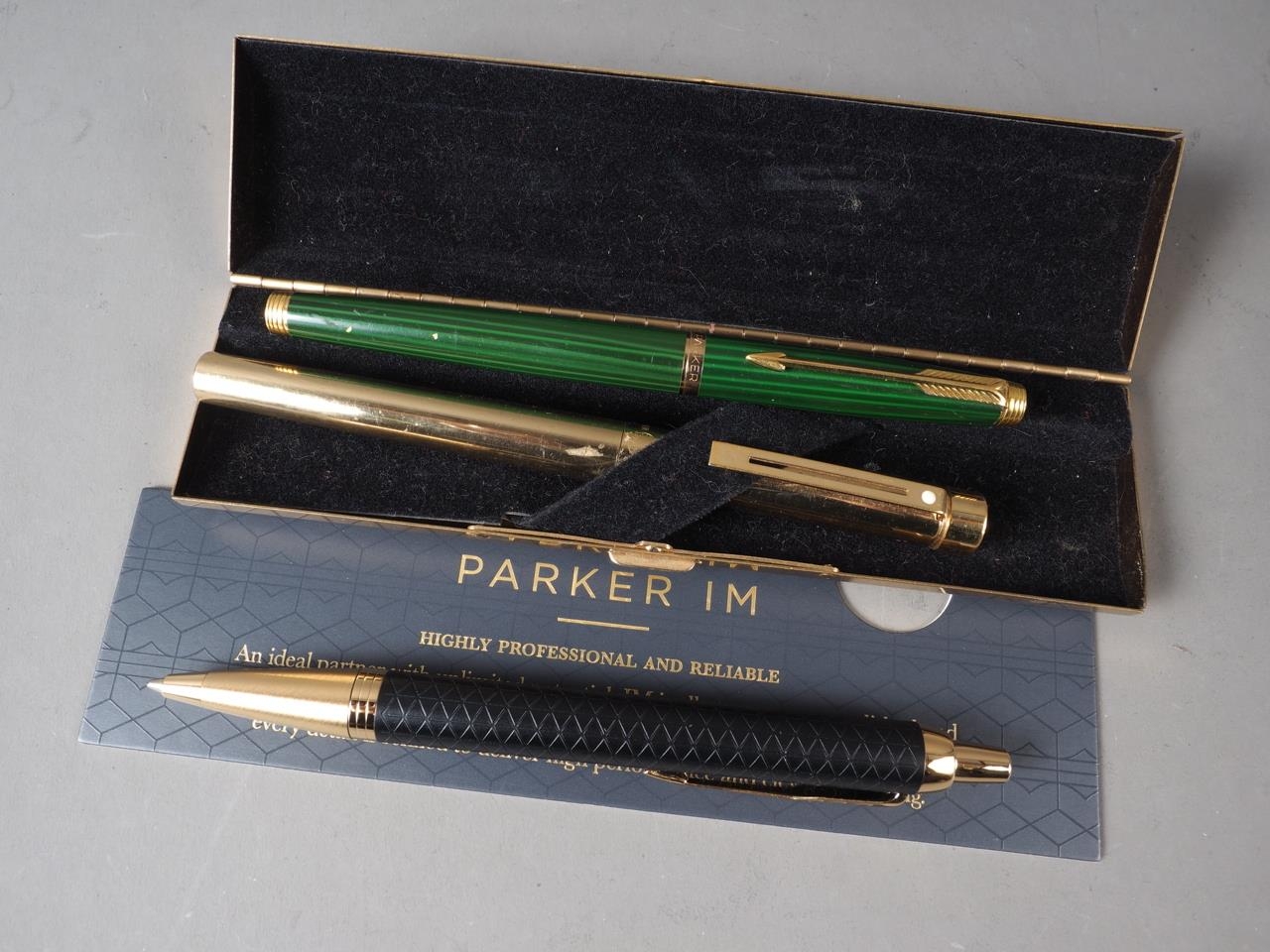 A green lacquered Parker fountain pen, a Sheaffer "Imperial Brass" fountain pen, in box, and a