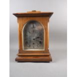 An early 20th century walnut cased bracket clock with silvered dial and eight-day striking and