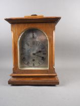 An early 20th century walnut cased bracket clock with silvered dial and eight-day striking and