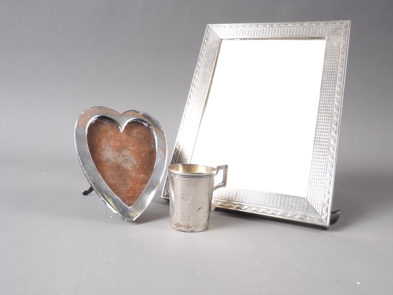 A Goldsmiths and Silversmiths silver photo frame with engine turned decoration, 6 1/2" x 4 3/4", a