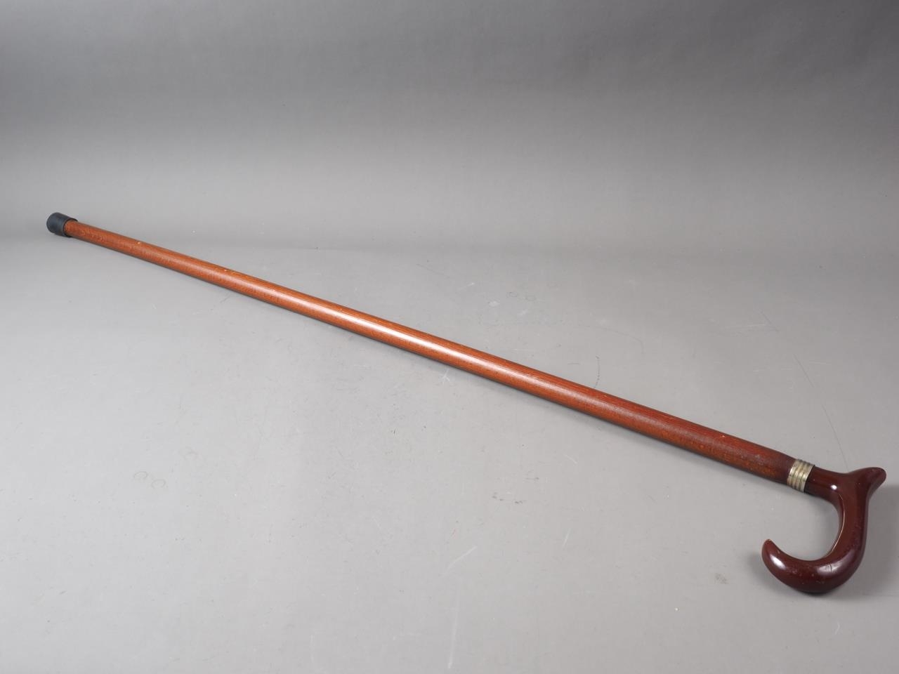 A walking stick with red Bakelite handle, 36 1/4" long