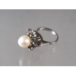 A 1950s white metal, stamped 14k, pearl and diamond set cocktail ring, pearl 9.5mm dia approx