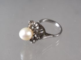 A 1950s white metal, stamped 14k, pearl and diamond set cocktail ring, pearl 9.5mm dia approx