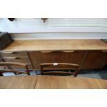 A 1960s McIntosh sideboard, fitted three drawers and three doors enclosed shelves, cellarette and