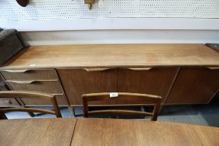 A 1960s McIntosh sideboard, fitted three drawers and three doors enclosed shelves, cellarette and