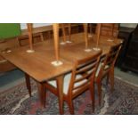 A 1960s McIntosh teak extending dining table, 78" wide x 36" deep x 29" high, and a set of seven