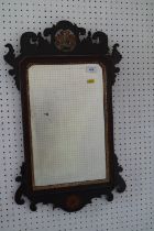 A walnut framed wall mirror of early 18th century design with pierced and gilt crest and bevelled