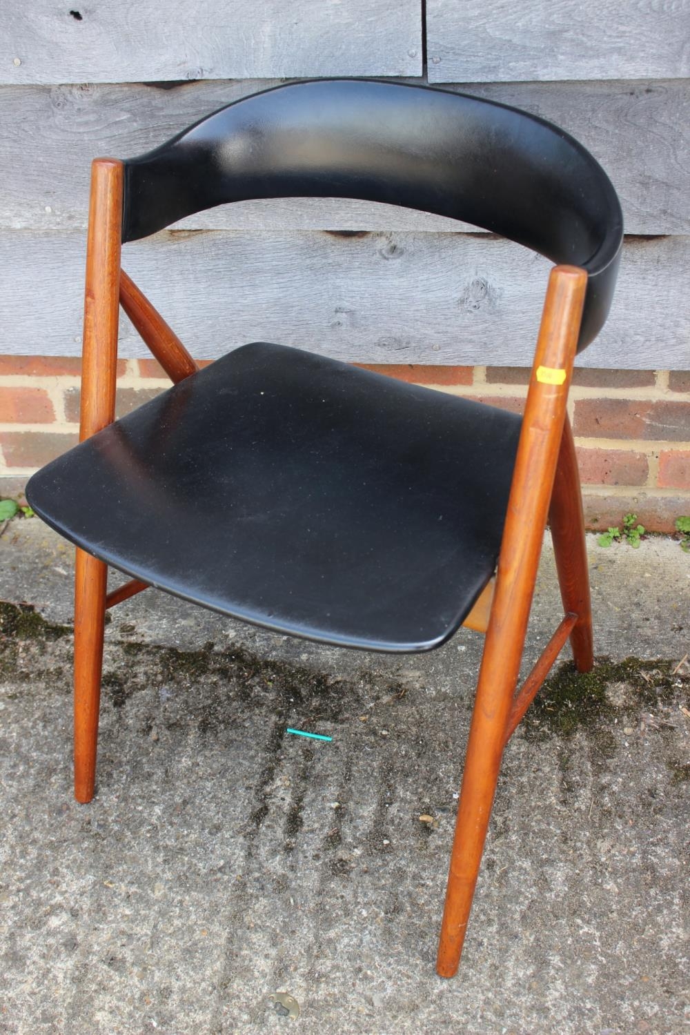 A 1960s Danish teak chair with shaped padded back and seat, on turned splay supports