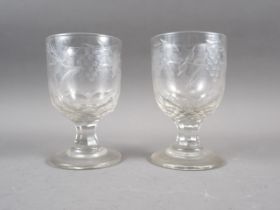 A pair of 19th century cut glass goblets with engraved vine leaf decoration, on faceted stems, 5 3/