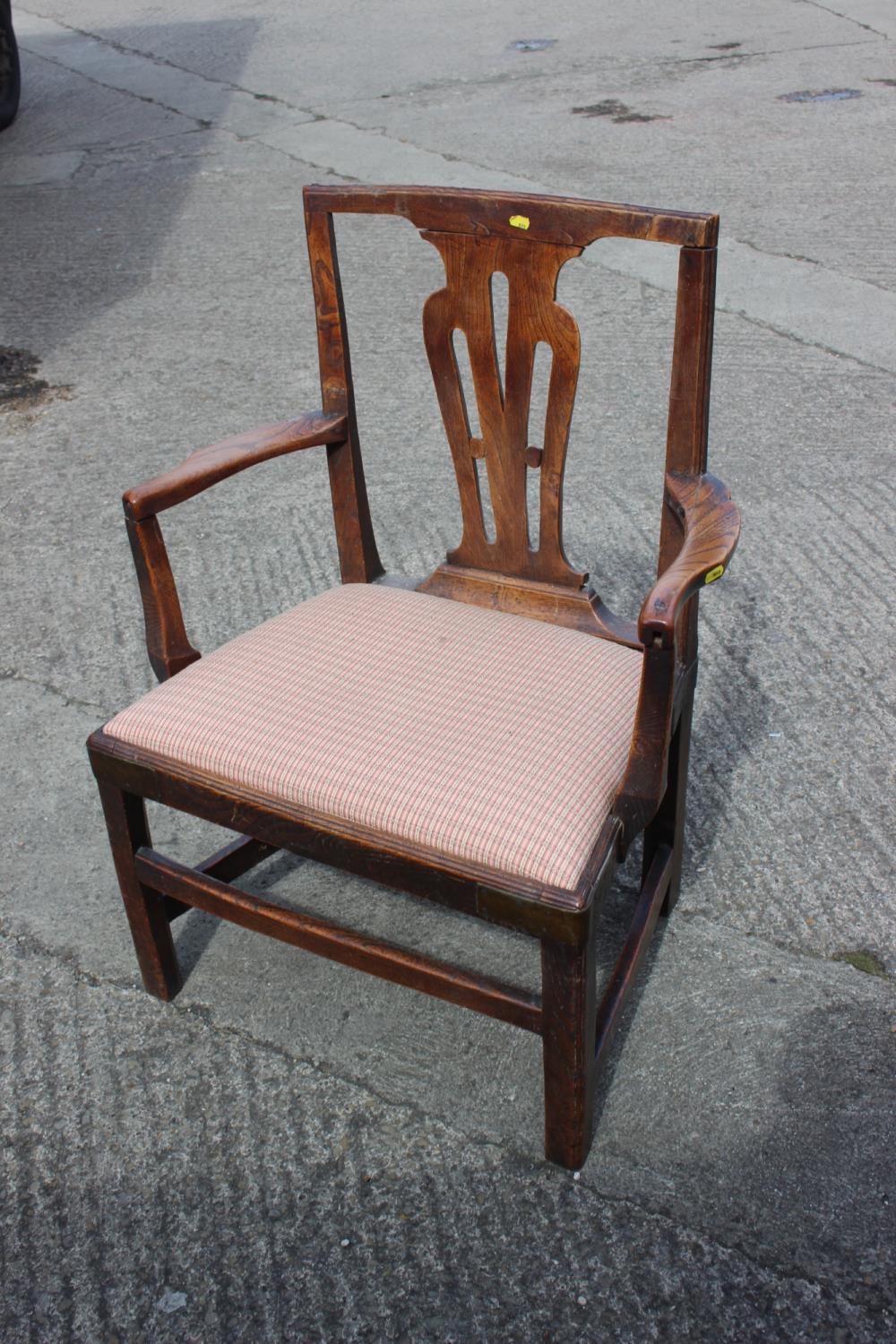 A Georgian provincial oak carver chair with drop-in seat, on square taper supports (repairs)