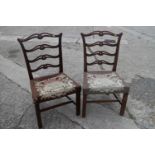 A pair of late 18th century carved mahogany ladder back dining chairs with near contemporary gros
