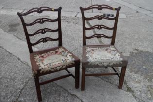 A pair of late 18th century carved mahogany ladder back dining chairs with near contemporary gros