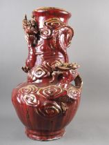 A Chinese sang de boeuf glazed vase with relief dragon and cloud decoration, 22" high
