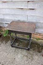 An 18th century oak side table, on tapering barley twist and stretchered supports, 27" wide x 19"