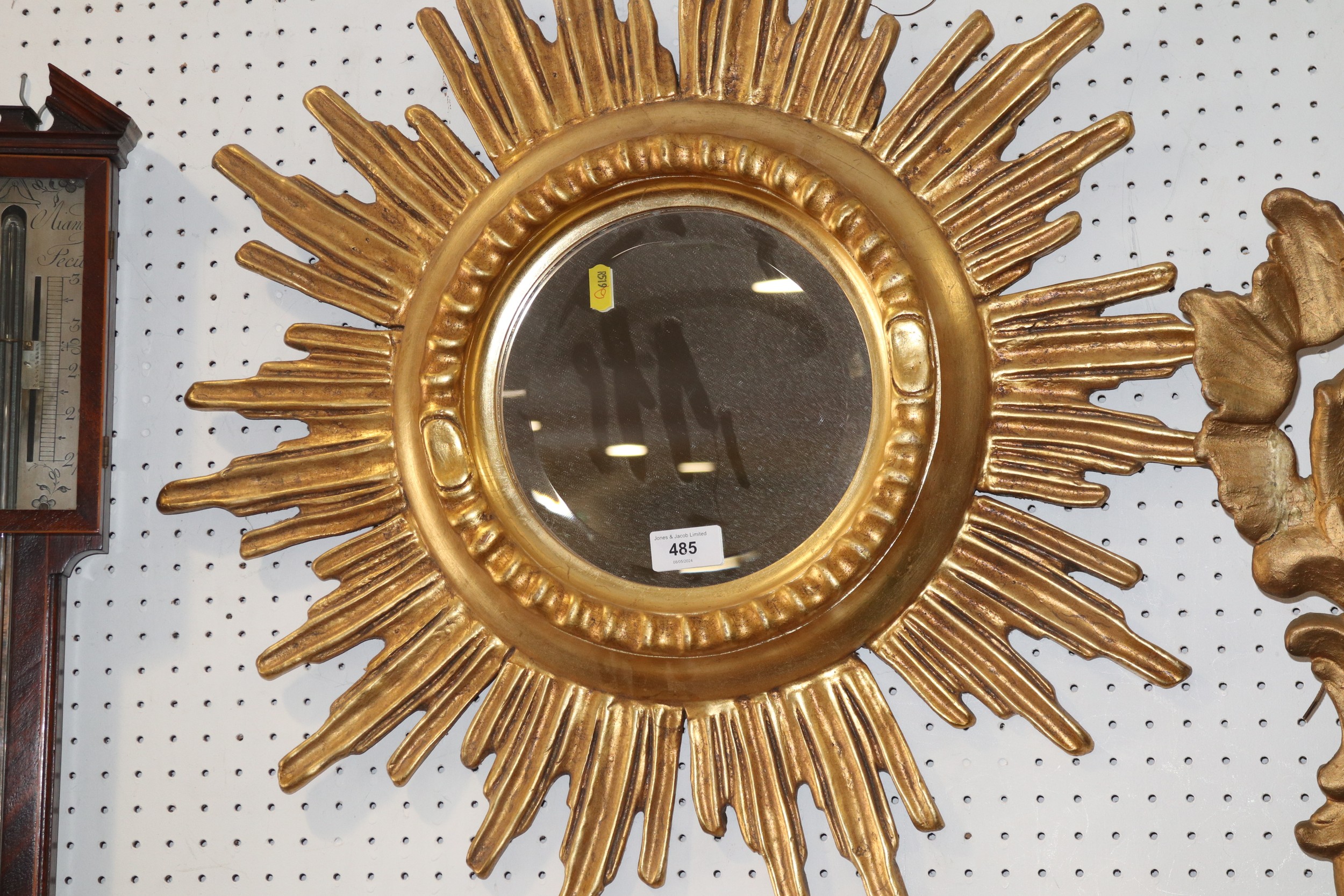 A carved giltwood framed starburst convex wall mirror, 24" max dia