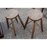 A pair of oak stools with elm tops, another smaller similar stool and two others
