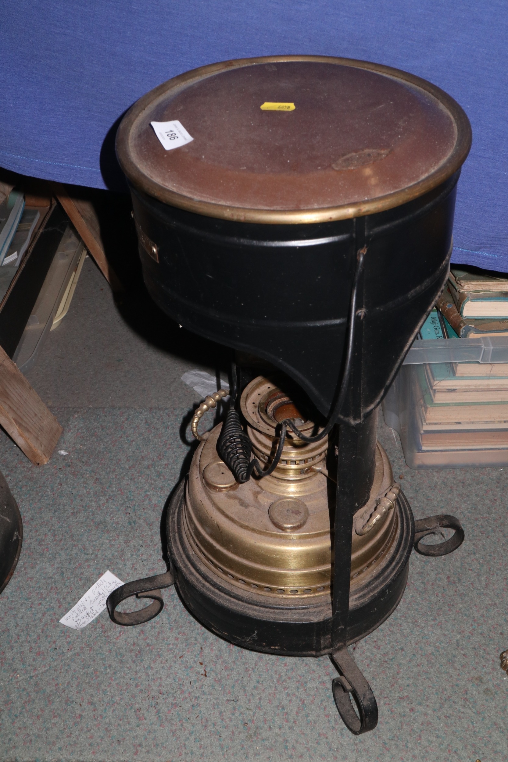 A "Blue Flame" brass and black metal oil burner room heater, on four scrolled supports, 12 1/2" high