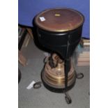 A "Blue Flame" brass and black metal oil burner room heater, on four scrolled supports, 12 1/2" high