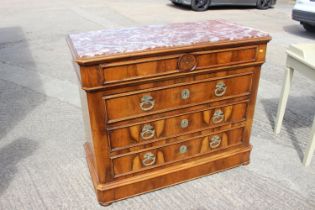 A Continental walnut chest of four long graduated drawers with carved wooden handles and marble top,