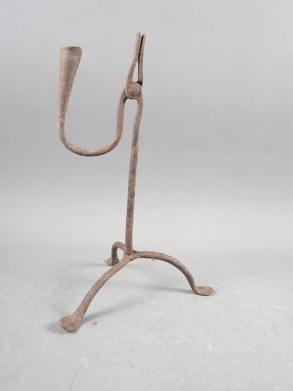 An antique wrought iron rush light holder, 11 1/4" high