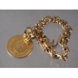 A yellow metal, stamped 18K, heavy link bracelet and Sacred Madonna pendant, 83.99g