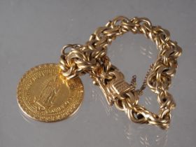 A yellow metal, stamped 18K, heavy link bracelet and Sacred Madonna pendant, 83.99g