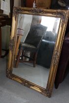 A bevelled edge wall mirror, in gilt frame, plate 29 1/2" x 19 1/2"