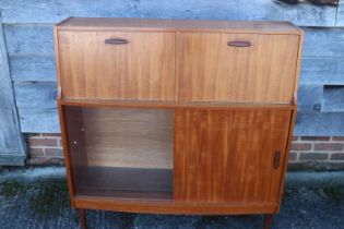 A 1960s Doncraft teak desk/cocktail cabinet with two fall front compartments over one glass and