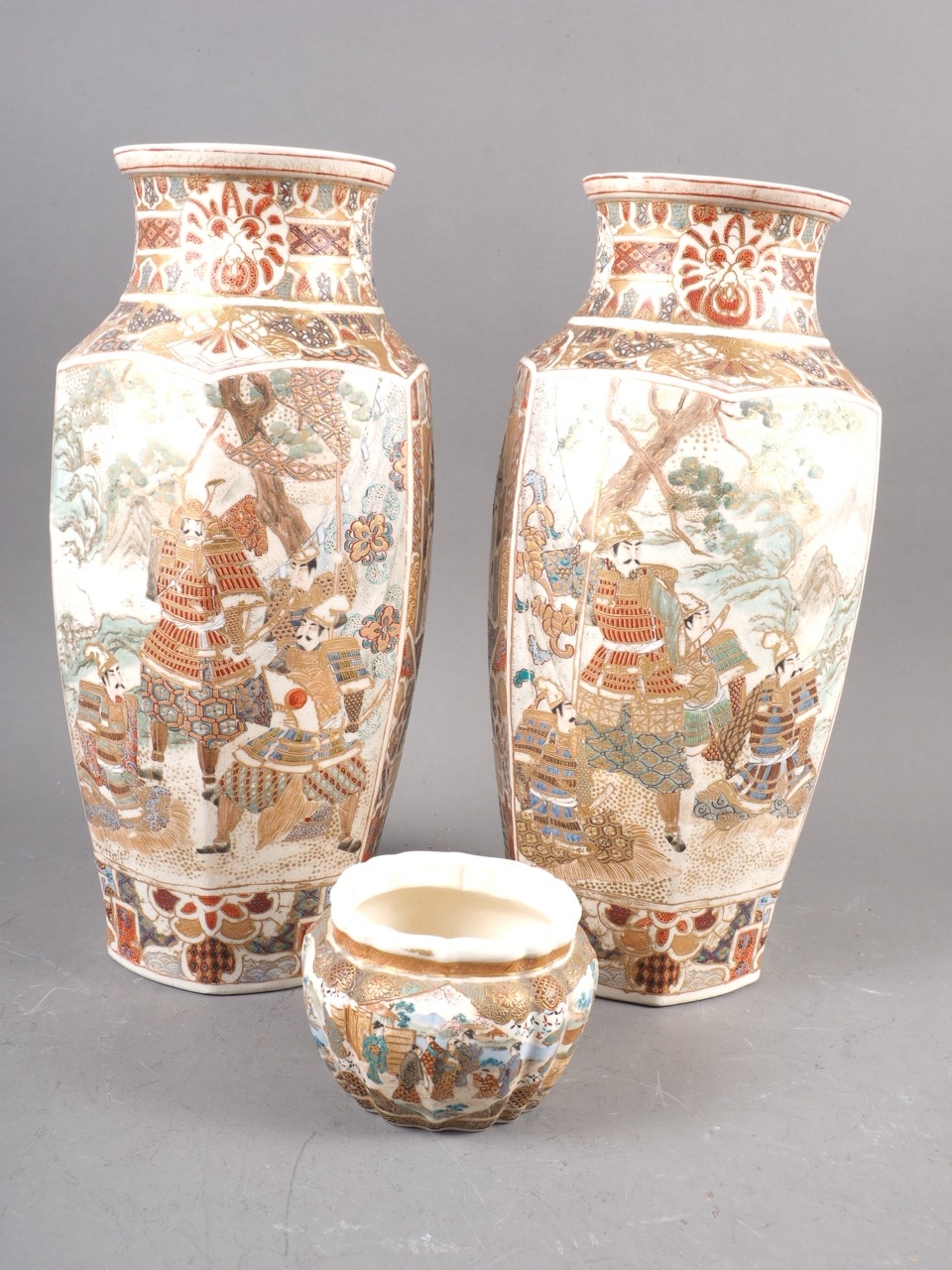 A pair of Japanese Satsuma faceted vases with figure decoration, 11 3/4" high, and a smaller similar