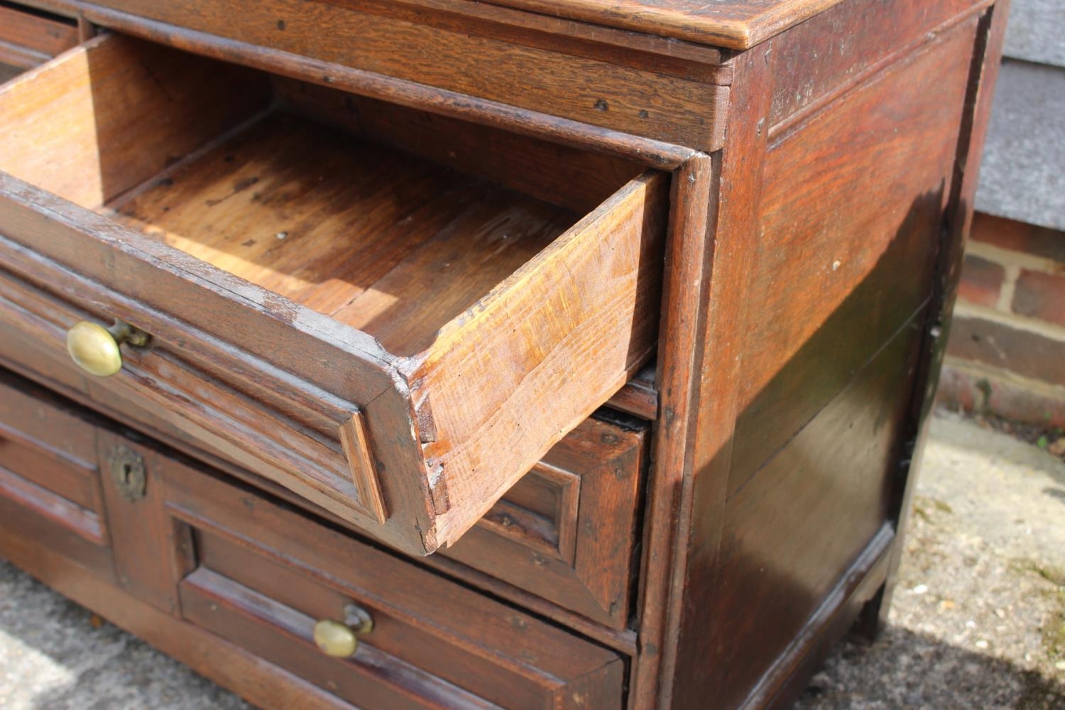 An 18th century oak panelled front chest fitted two short and two long drawers with brass knob - Image 2 of 4