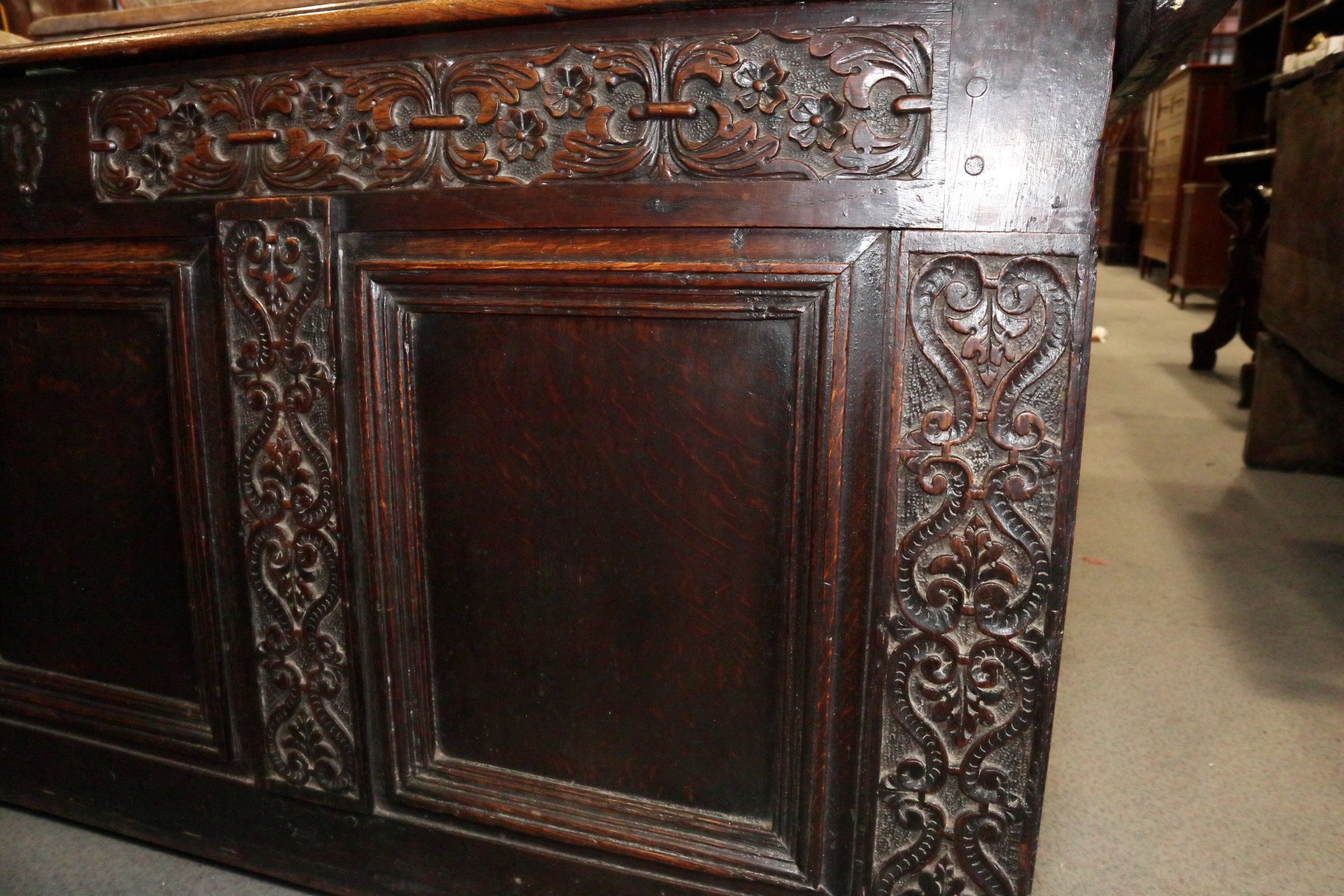 An early 18th century carved oak triple panel front coffer with scroll design and planked top, on - Image 2 of 5