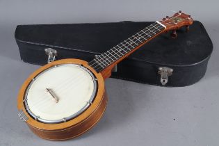 A Keech four-string banjolele, 21 1/2" long, with string inlaid resonator ring and scratched