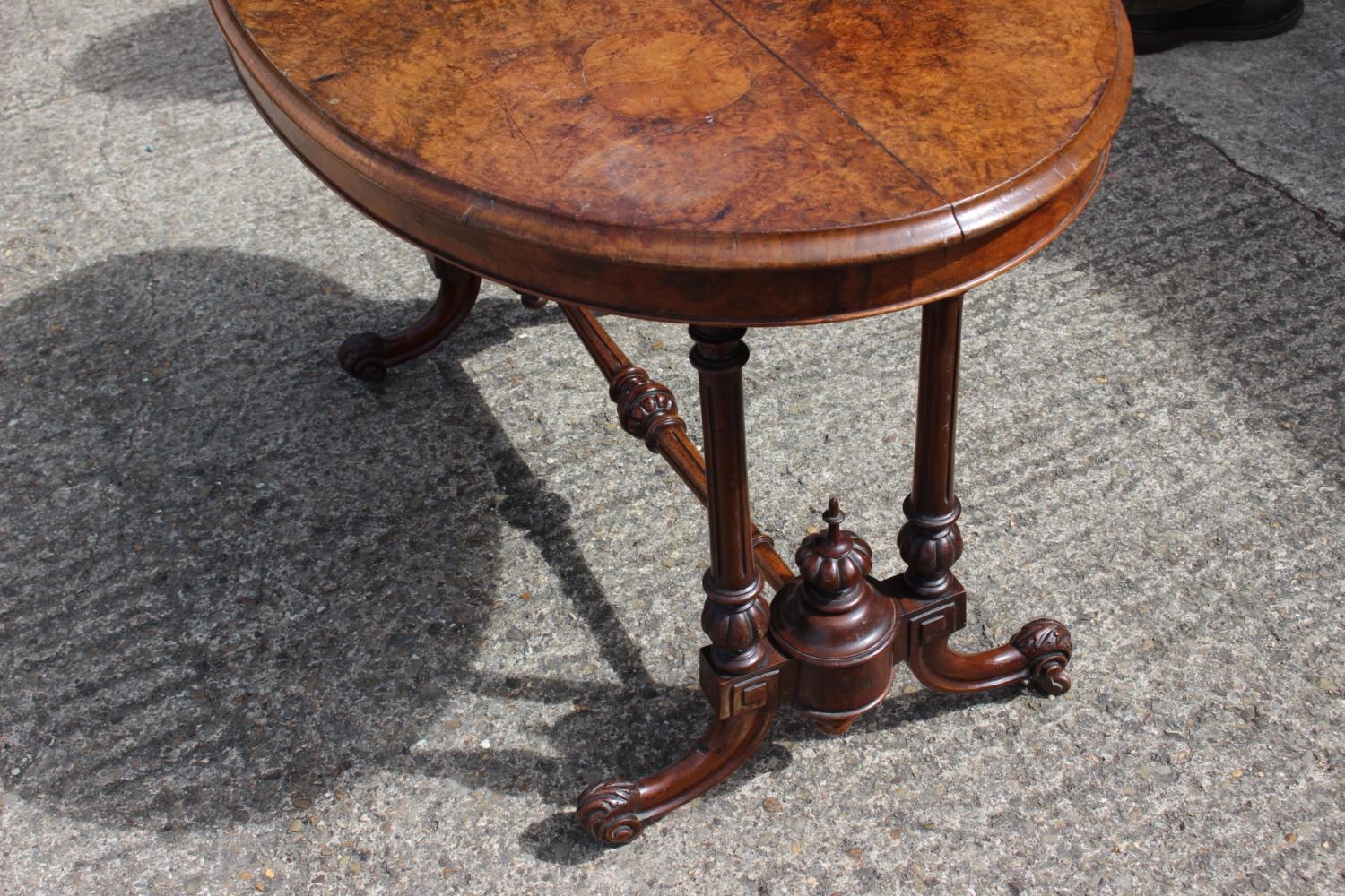 A late 19th century burr walnut oval occasional loo table, on twin turned and stretchered splay - Image 2 of 2