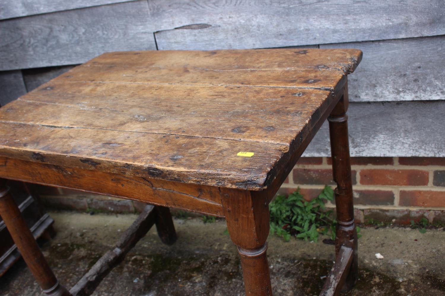 An 18th century oak side table with planked top, on turned and stretchered supports, 30 1/2" wide - Image 2 of 2